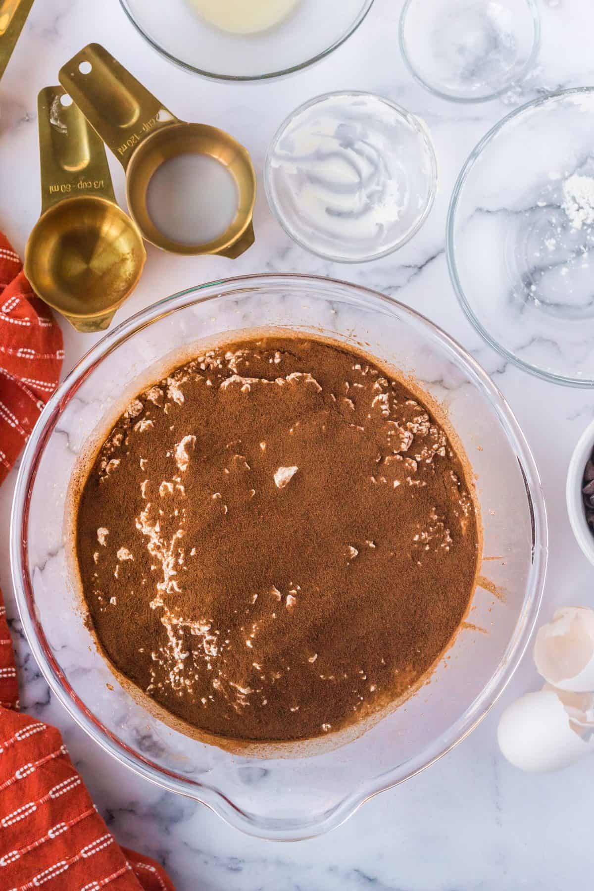 adding the dry ingredients to the wet ingredients for the tiramisu bundt cake recipe